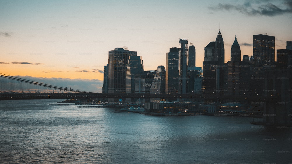 a city skyline with a bridge in the foreground