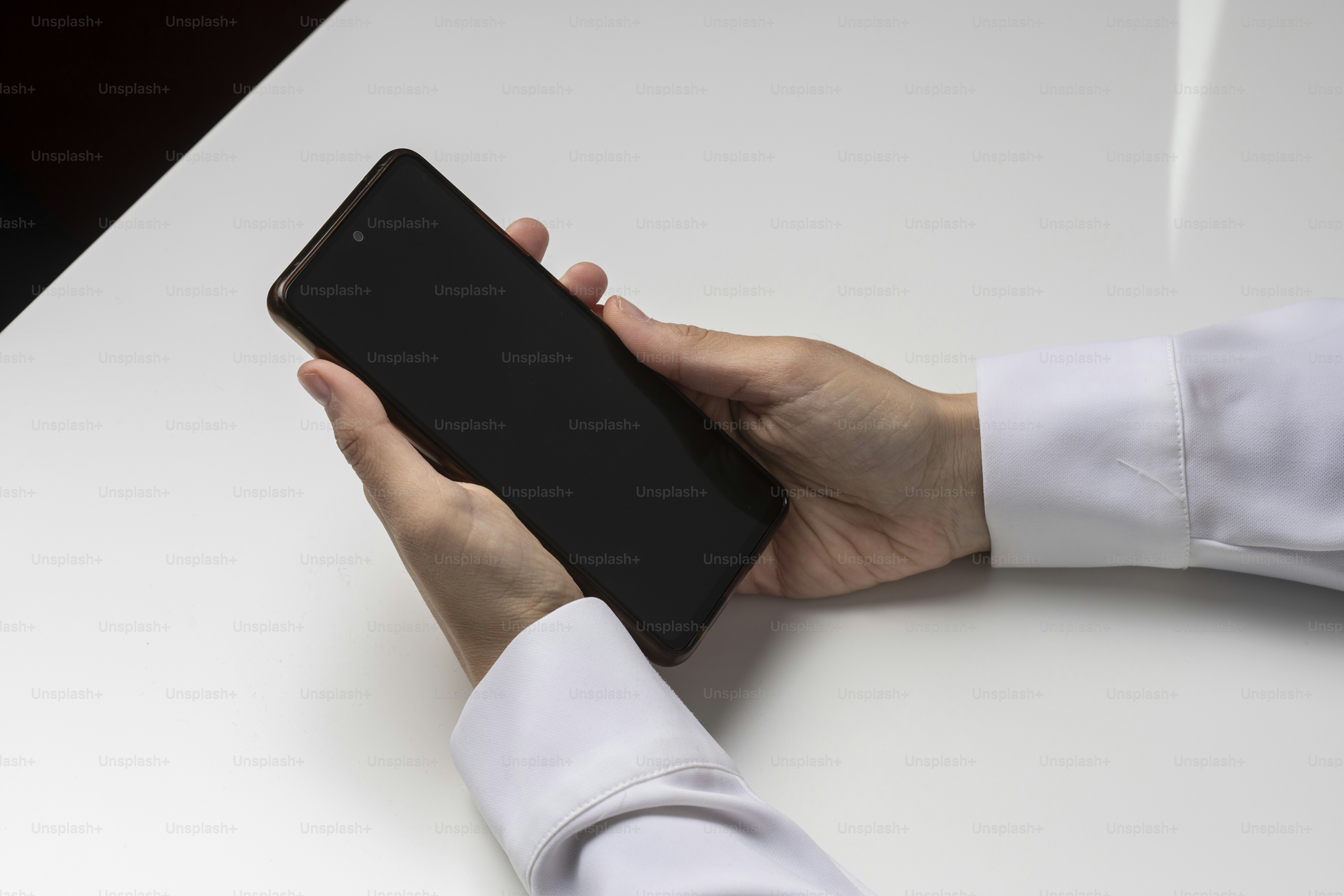 a person holding a cell phone in their hand