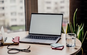 a laptop computer sitting on top of a wooden table