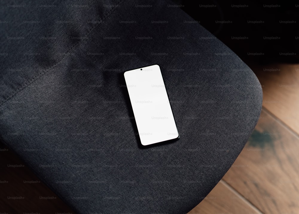 a cell phone sitting on top of a black chair