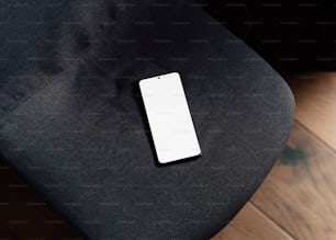 a cell phone sitting on top of a black chair