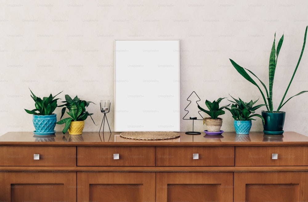 a wooden dresser topped with lots of potted plants