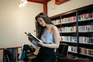 Une femme lisant un livre dans une bibliothèque
