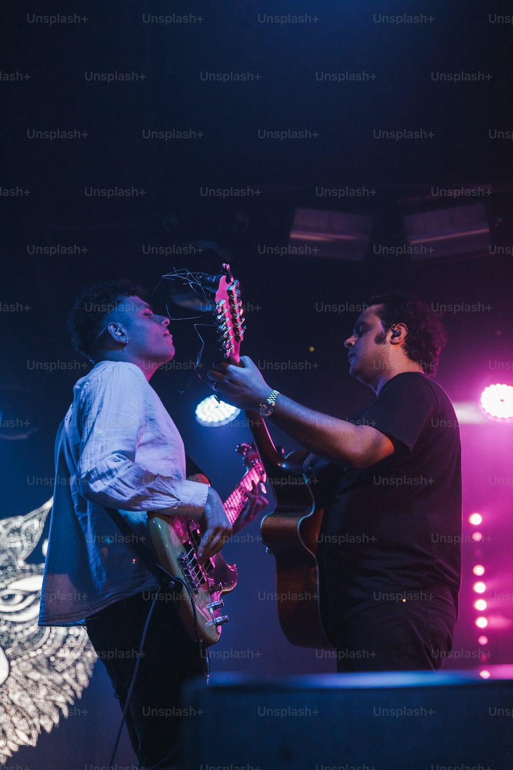 a couple of men standing on top of a stage