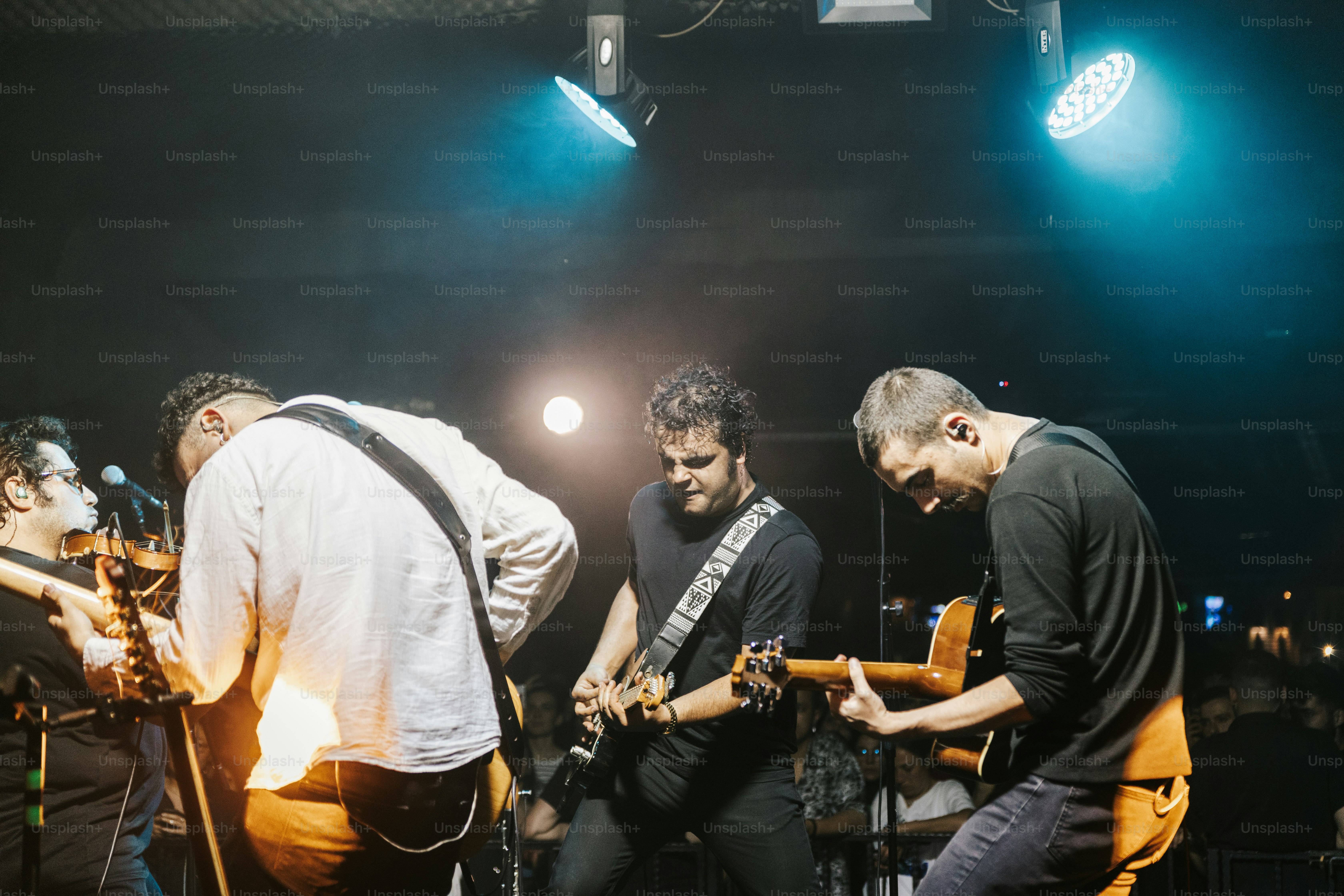 a group of men standing on top of a stage