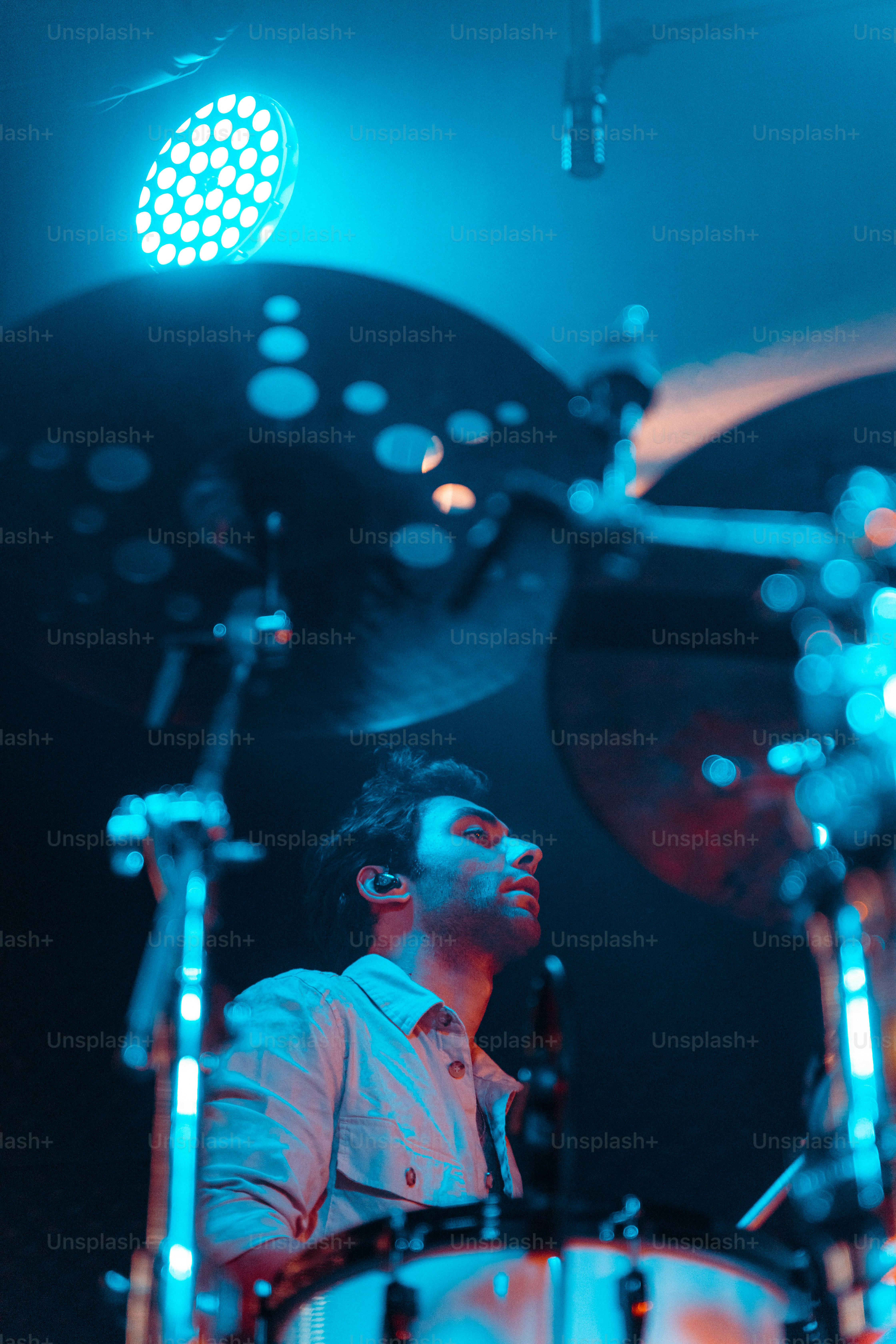 a man that is sitting in front of a drum set