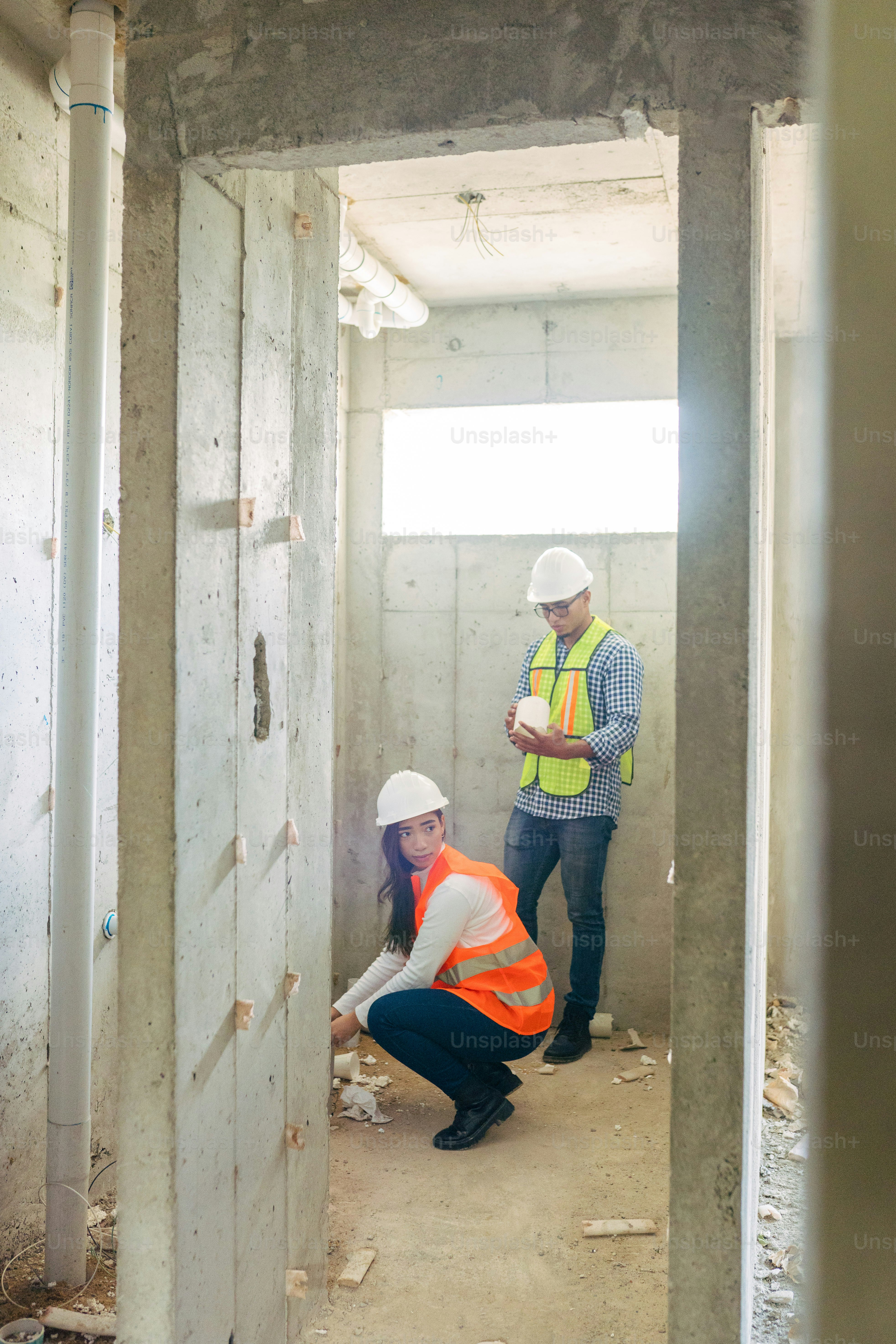 a woman kneeling down next to a man in a building
