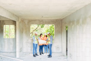 a group of people standing in a room under construction