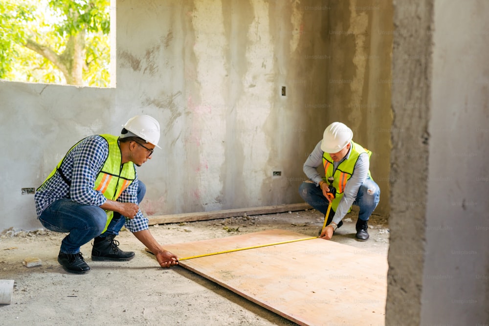 a couple of men standing next to each other on a floor