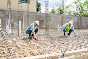 two construction workers working on a construction site