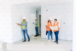 a group of construction workers standing in a room