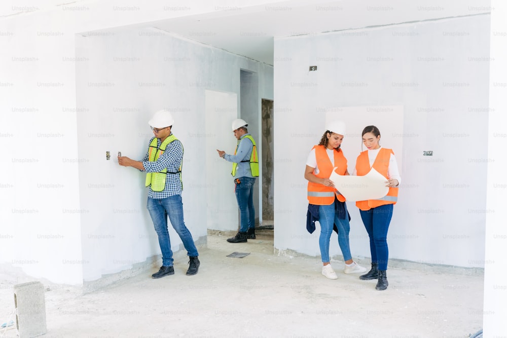 a group of construction workers standing in a room