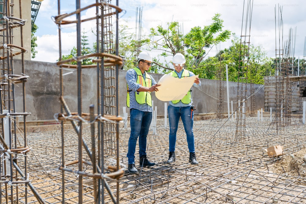 a couple of men standing next to each other on a construction site