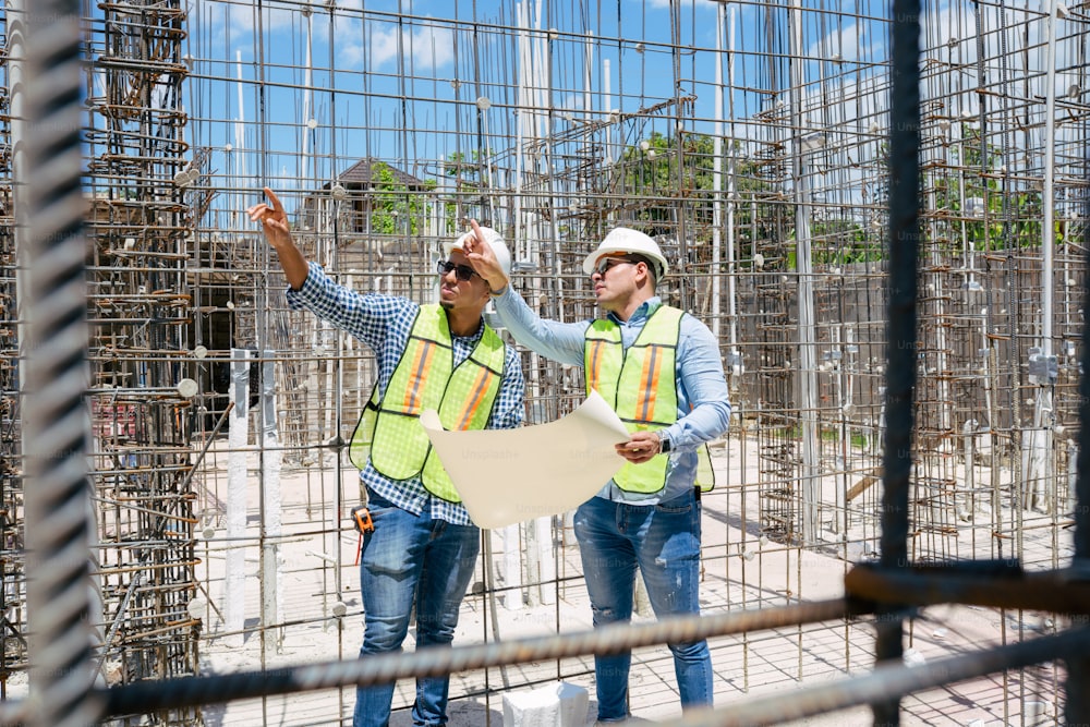 a couple of men standing next to each other on a construction site