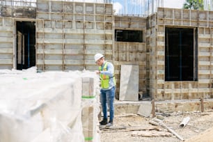 a man standing in front of a building under construction