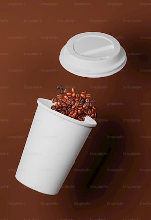 a coffee cup with coffee beans falling out of it