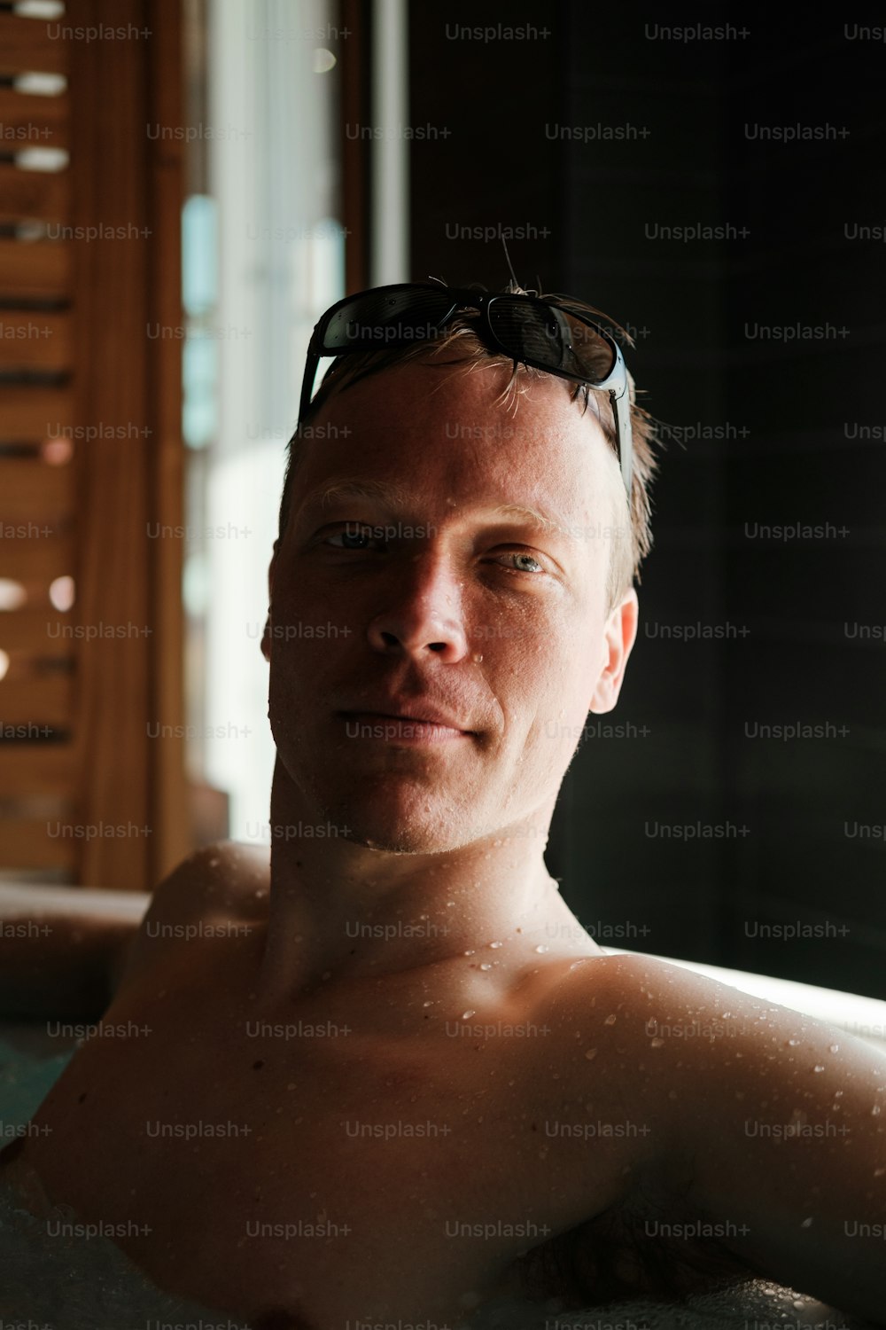 a man in a hot tub wearing sunglasses