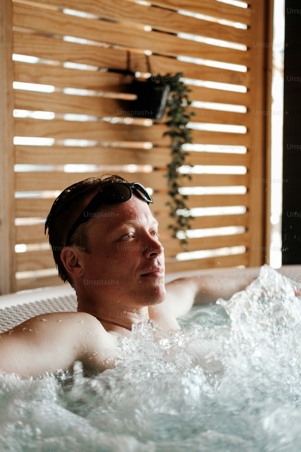 Un hombre se relaja en una bañera de hidromasaje