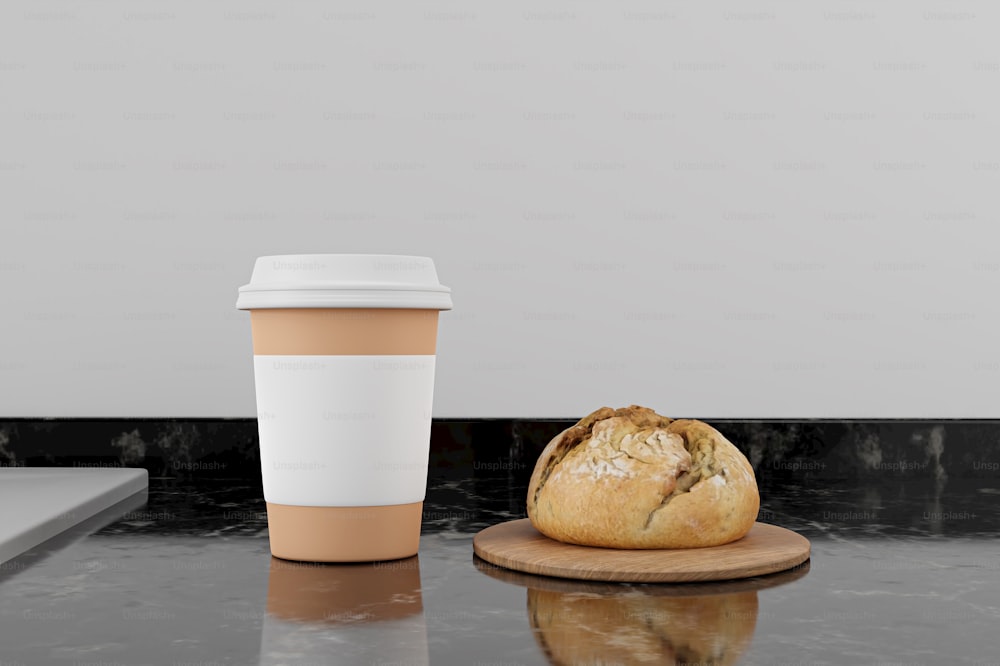 a cup of coffee next to a loaf of bread
