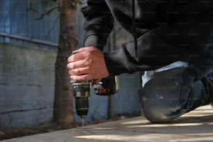 a man using a drill to drill concrete