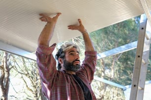 a man with a beard holding a white board