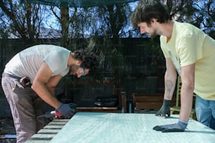 a couple of men working on a table