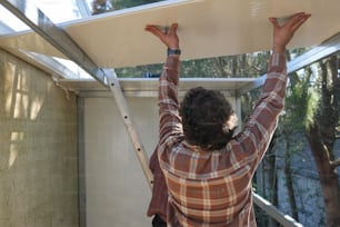 a man holding a surfboard over his head