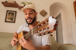 a man playing a guitar in a living room