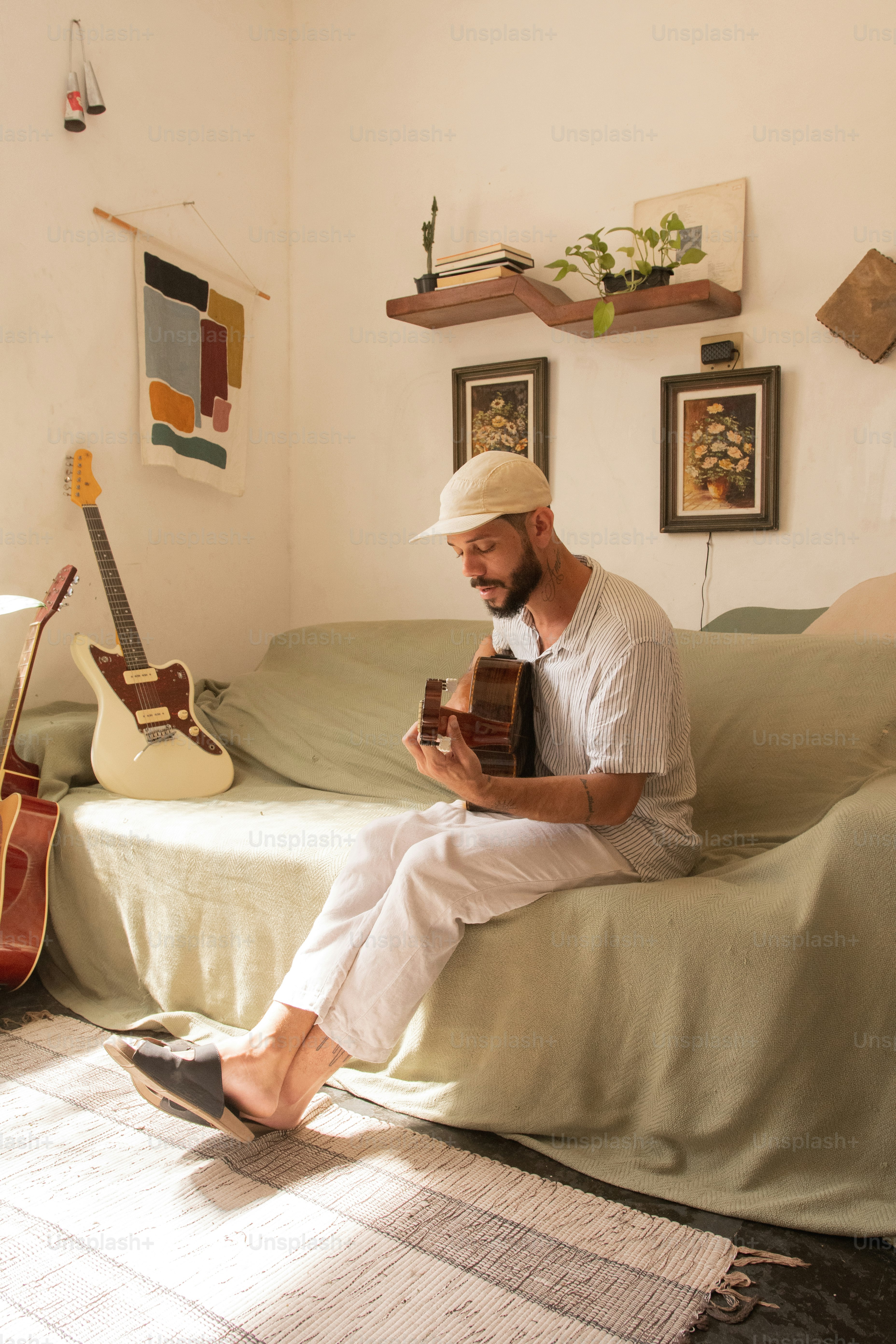 a man sitting on a couch holding a book