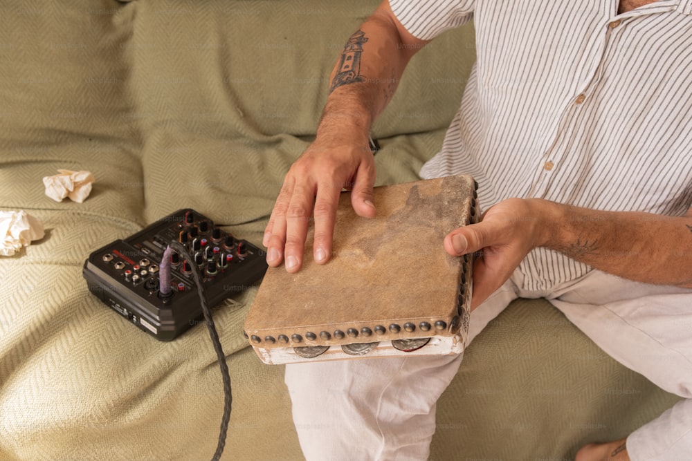 a man sitting on a couch holding a book