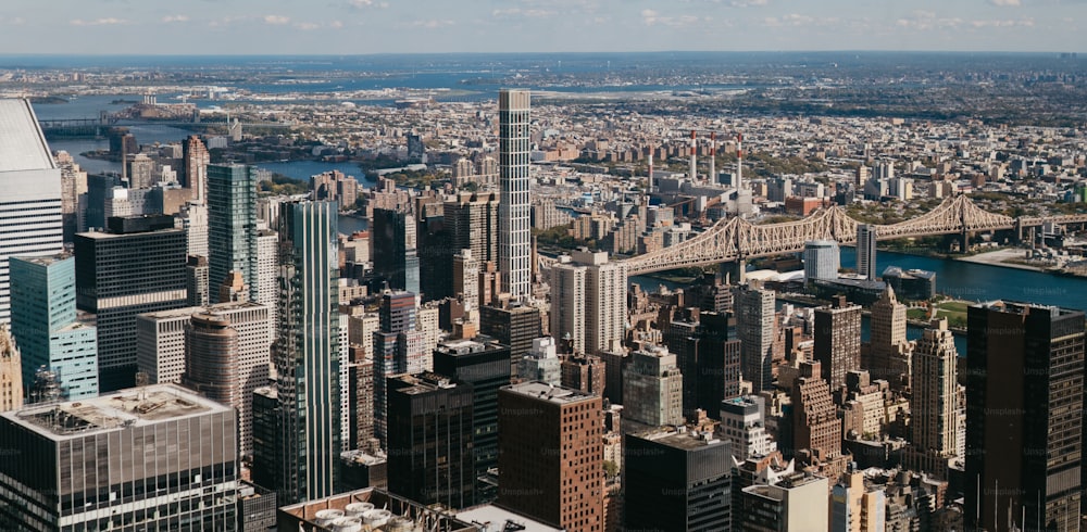 a view of a large city with a bridge in the background