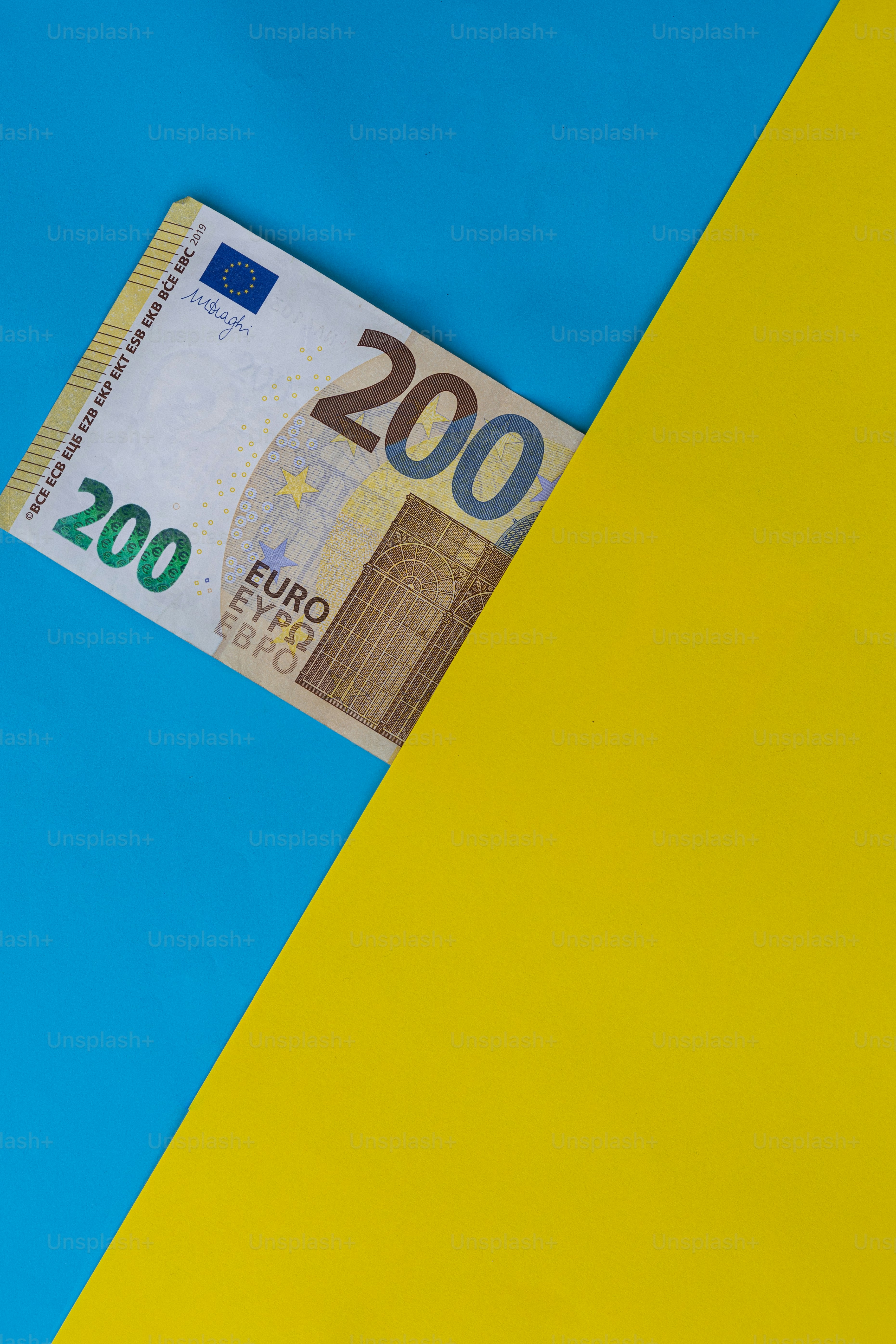 a hundred euros bill sticking out of a yellow and blue background
