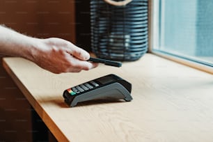 a person using a cell phone on a table