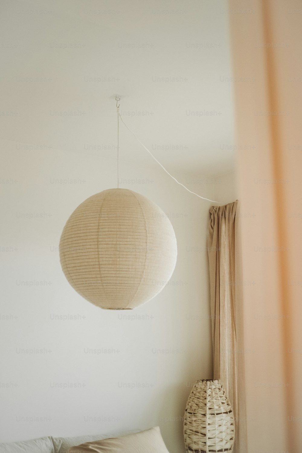 a bed room with a bed and a hanging light