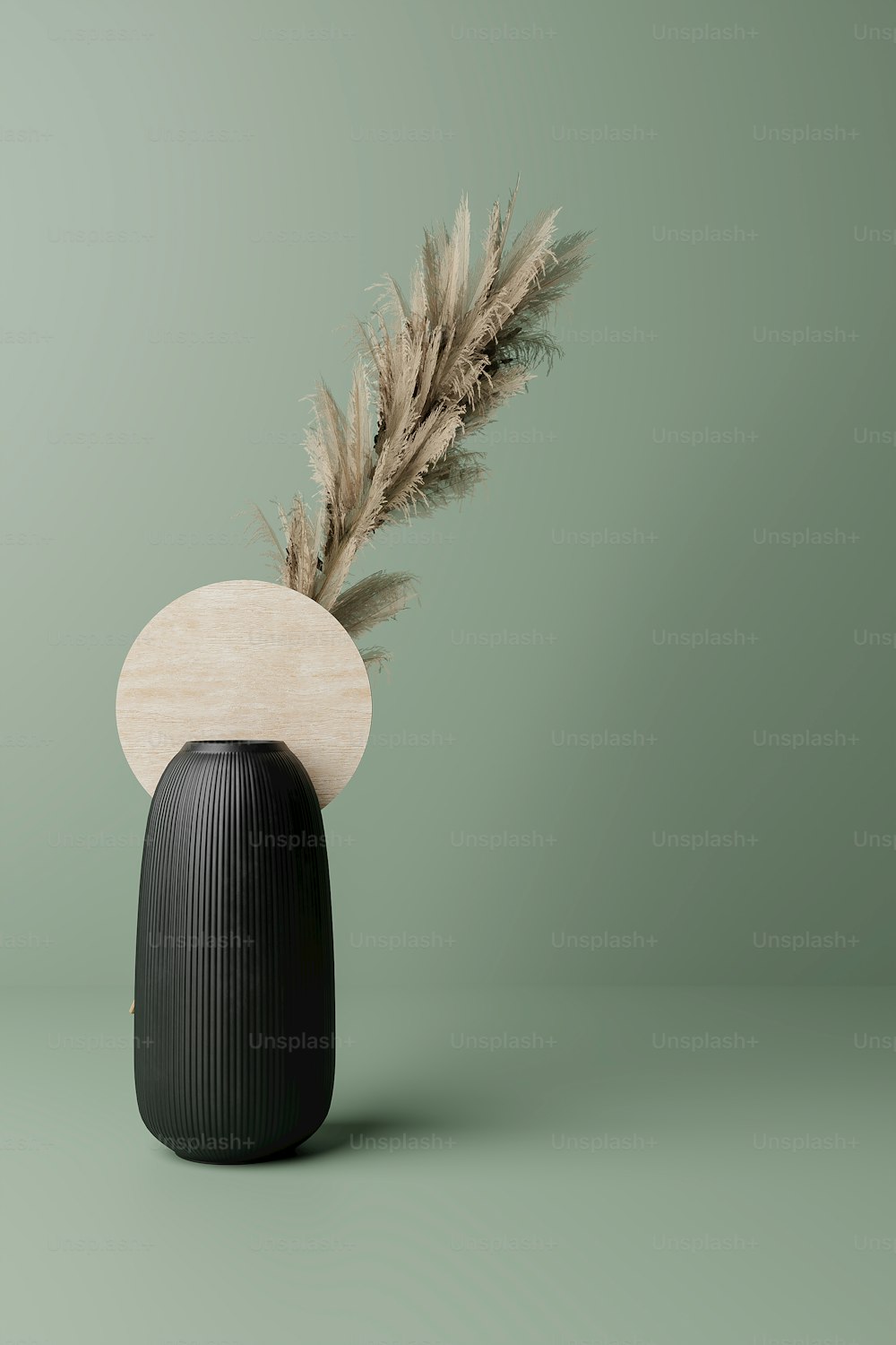 a black vase with a feather sticking out of it