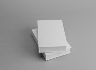 Ein Stapel weißer Bücher auf grauem Hintergrund