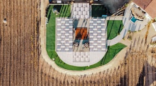 an aerial view of a farm house with a pool