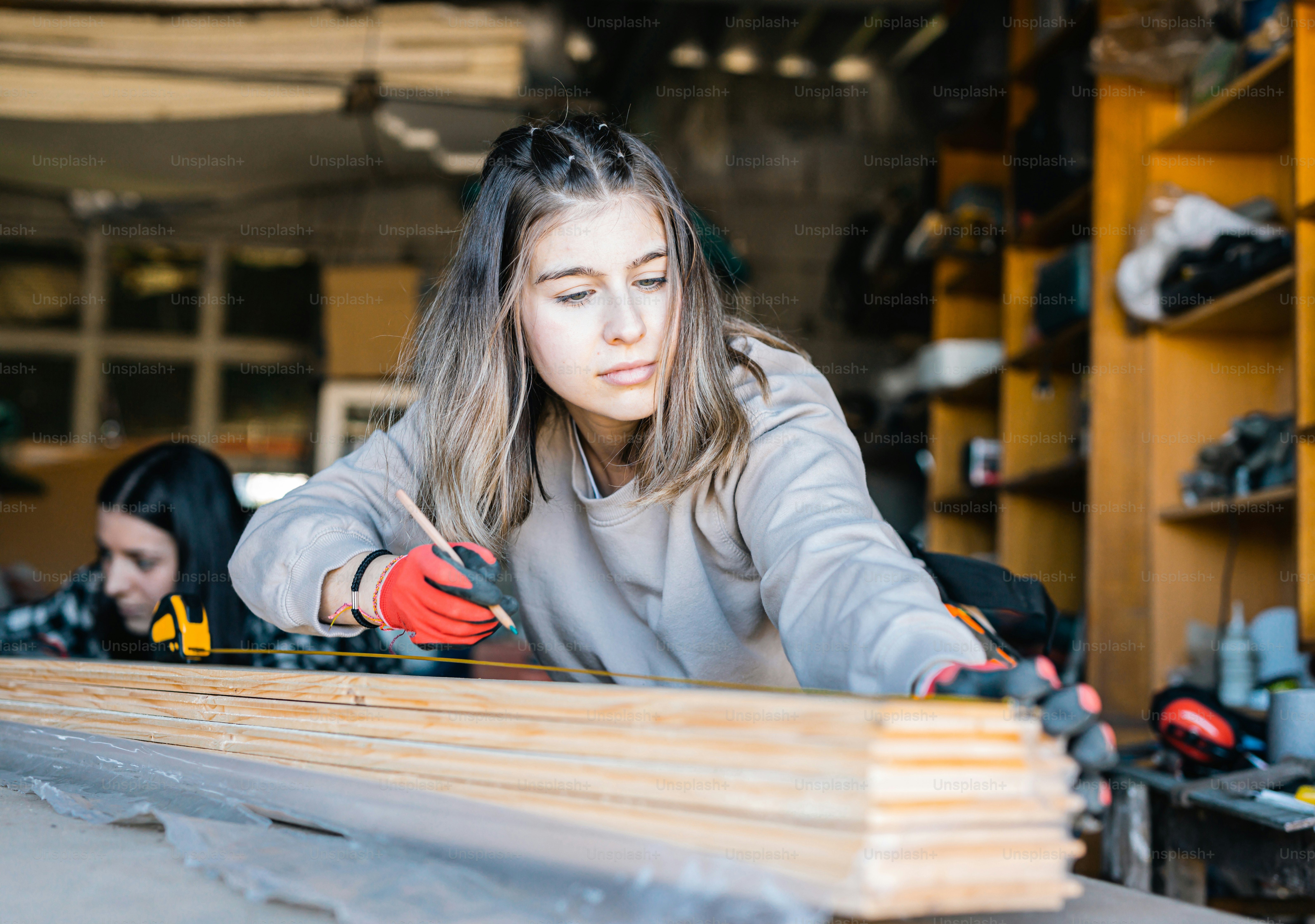 a woman working on a piece of wood