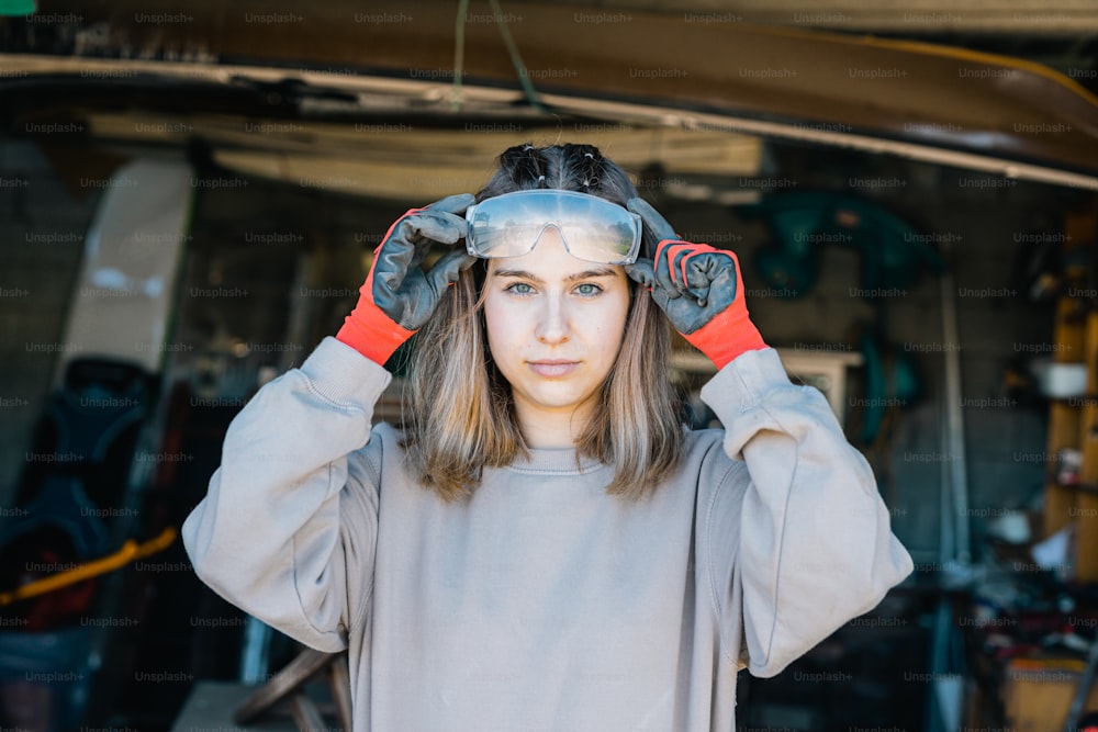 Une femme tenant une paire de gants sur la tête