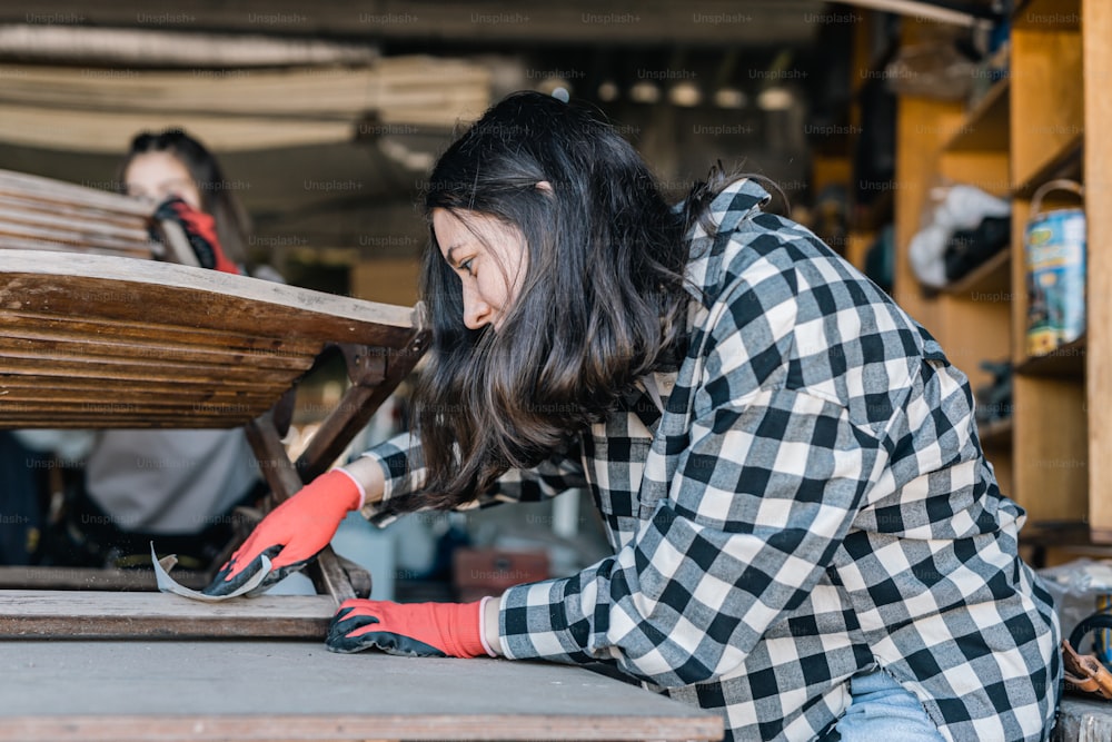 a woman working on a piece of wood