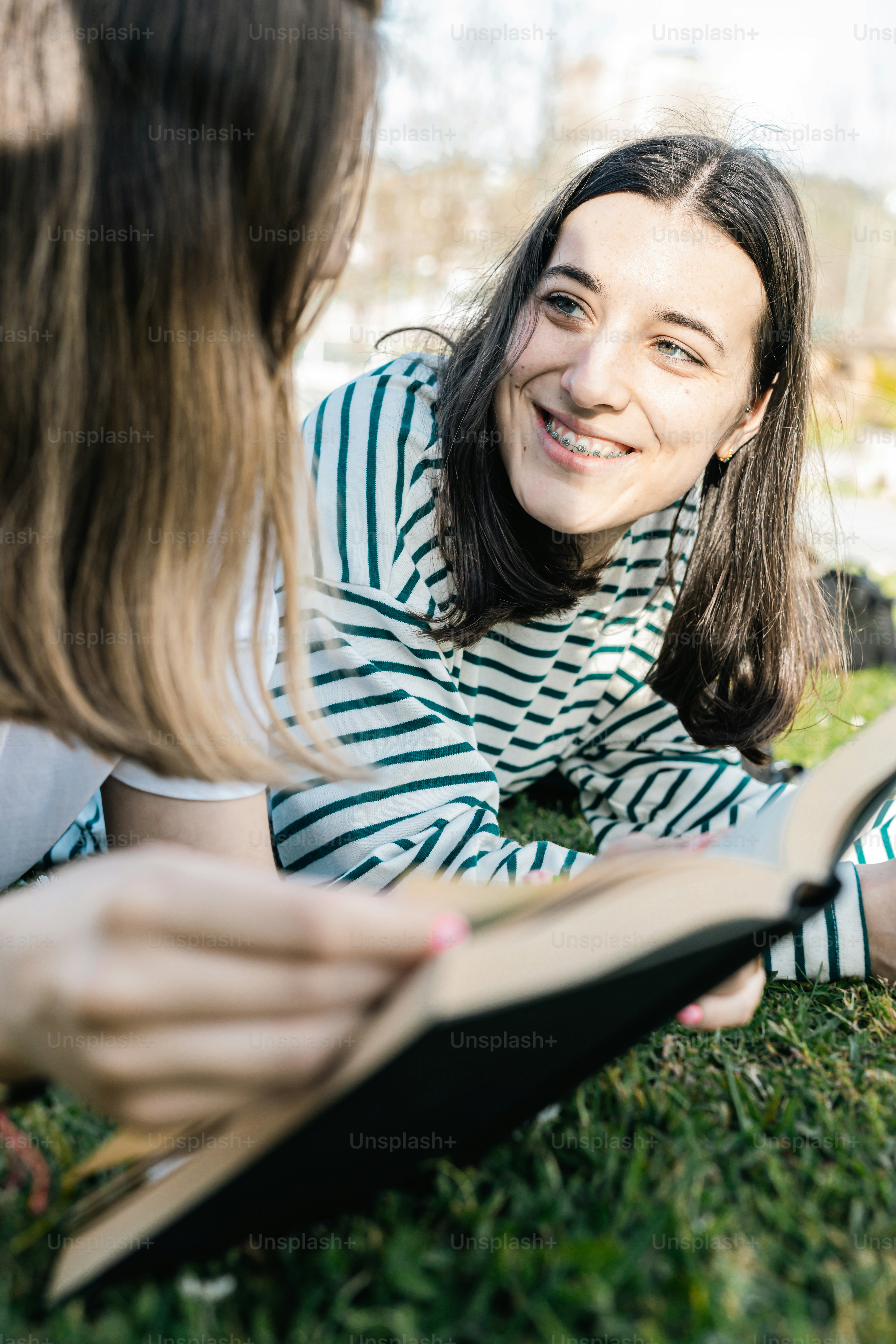 a woman reading a book to another woman