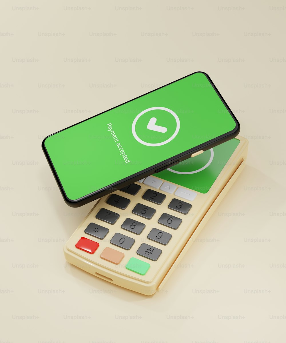 a green phone sitting on top of a calculator