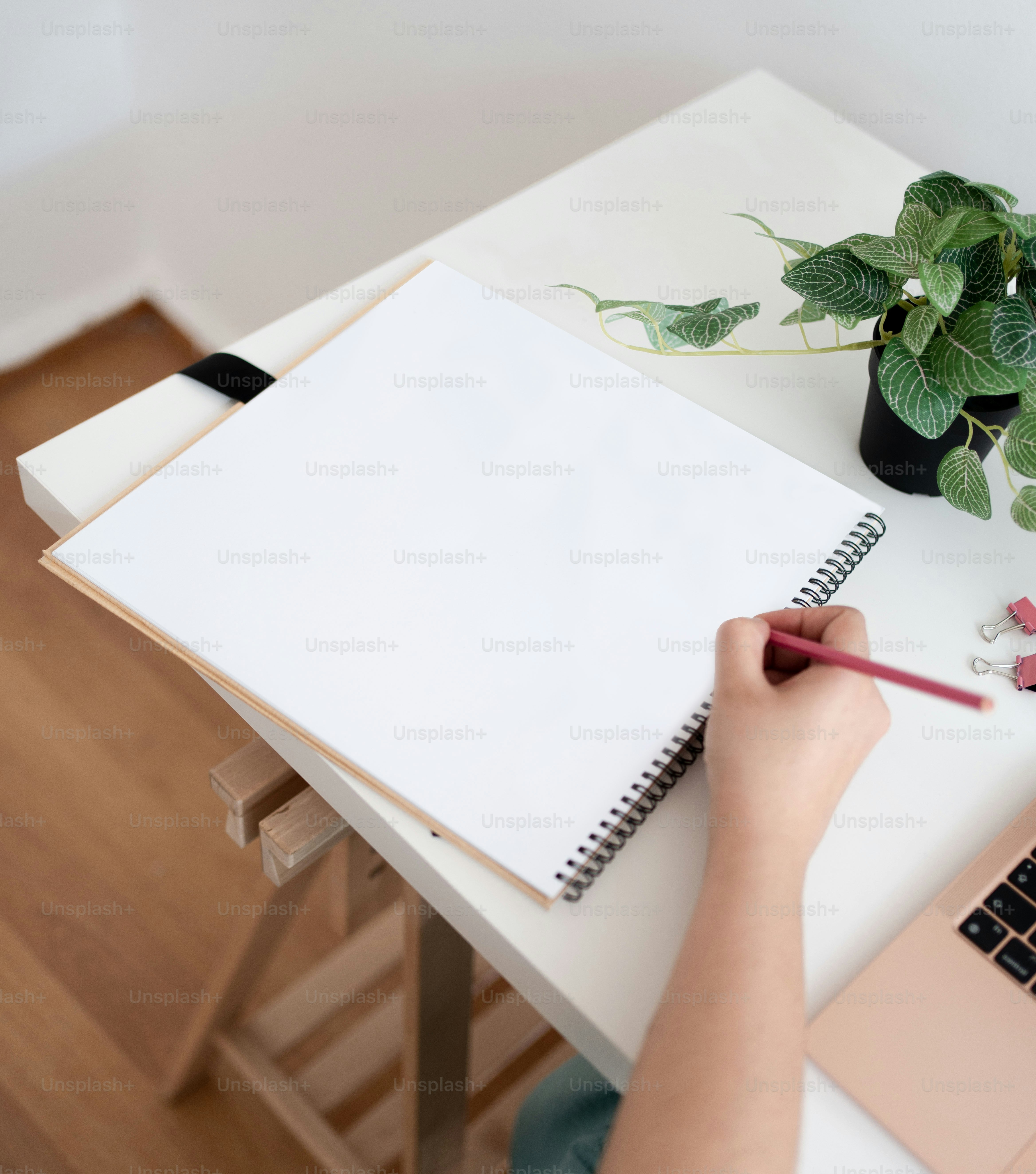 une personne écrit sur un cahier avec un stylo