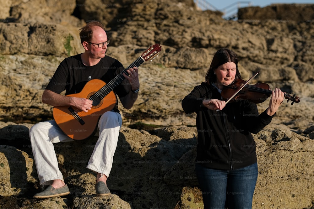 a man playing a violin and a woman playing a violin