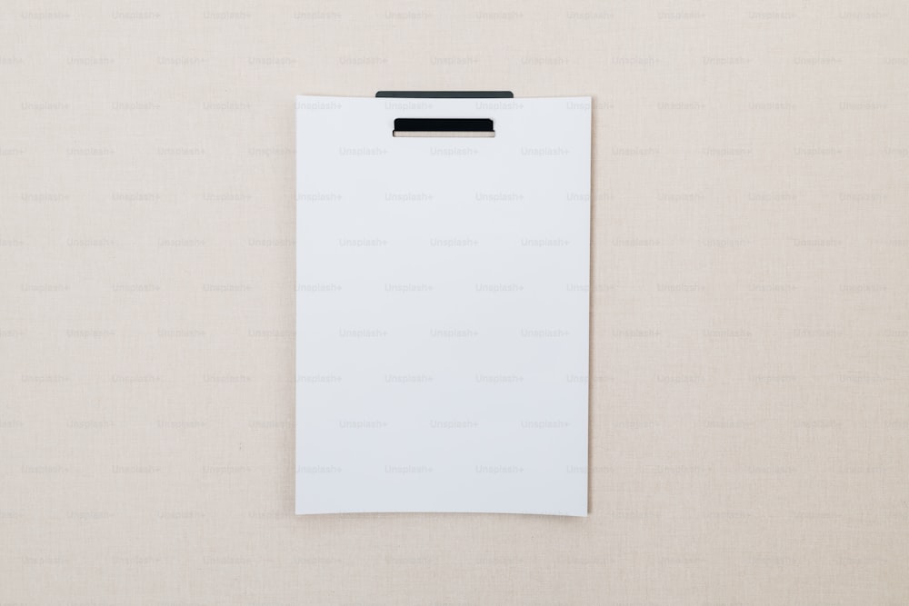 a white clipboard with a black clip on it