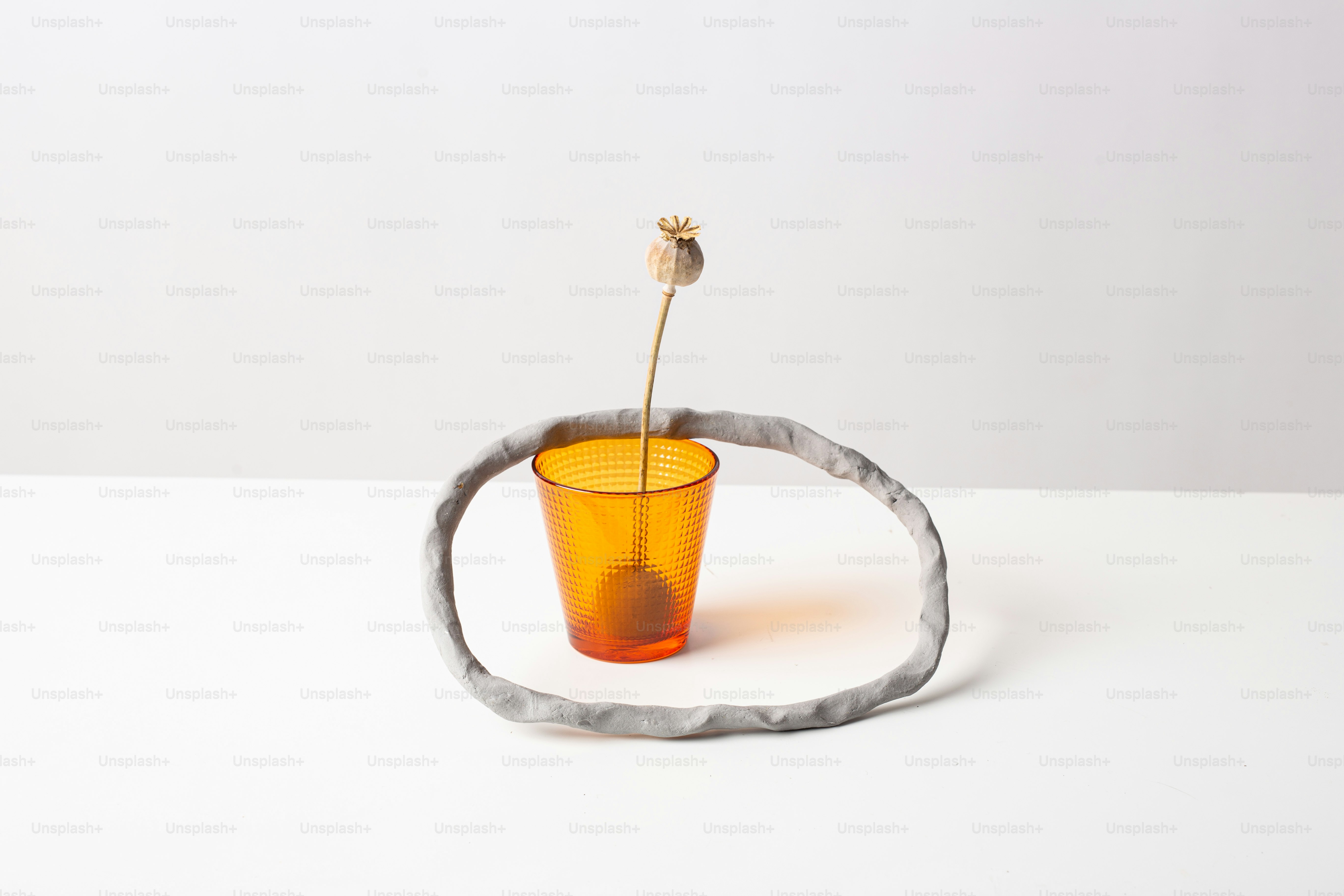 a vase with a flower in it sitting on a table