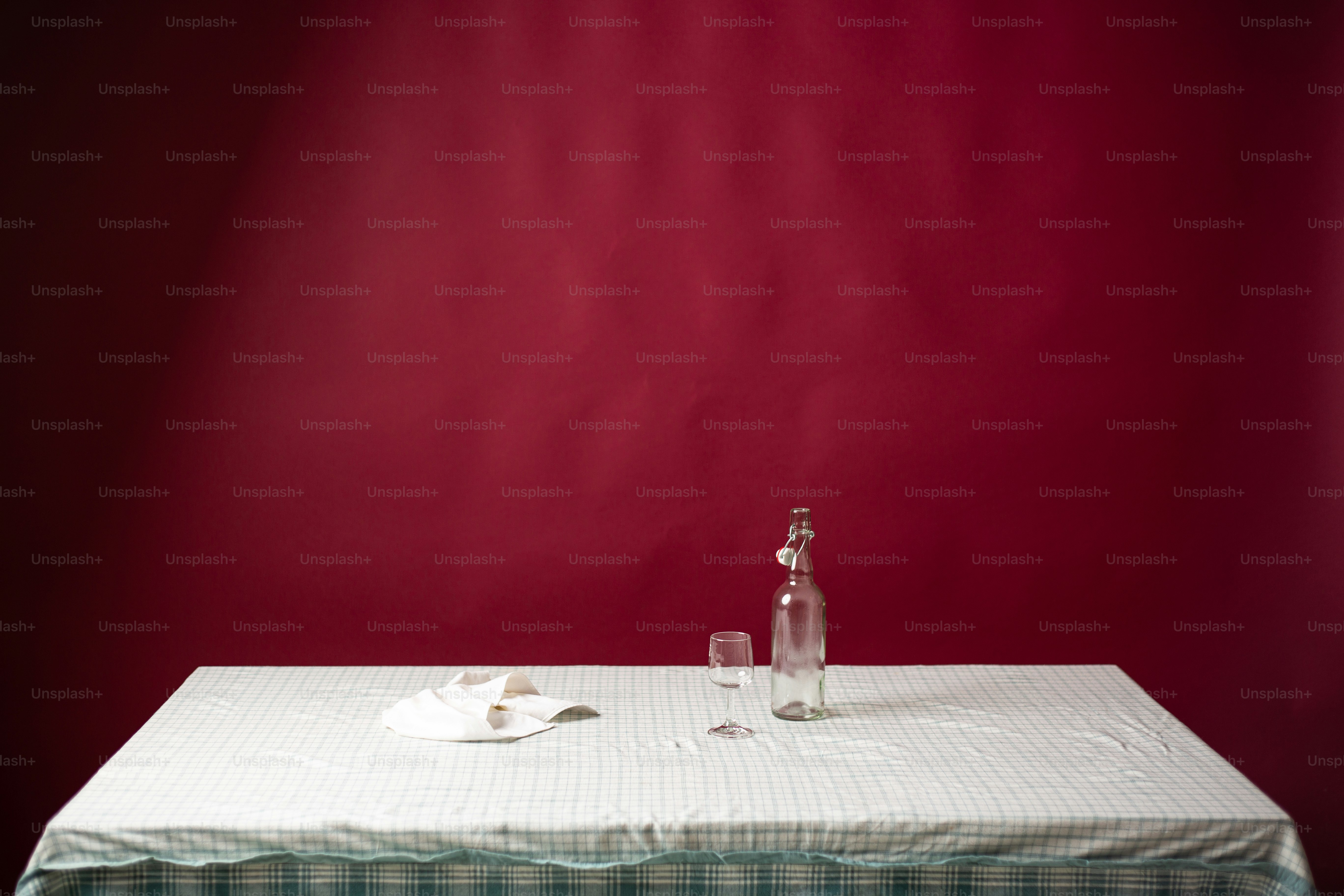 a table with a bottle of wine and a napkin on it