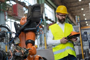 An automation engineer holding scanner in industrial in factory.