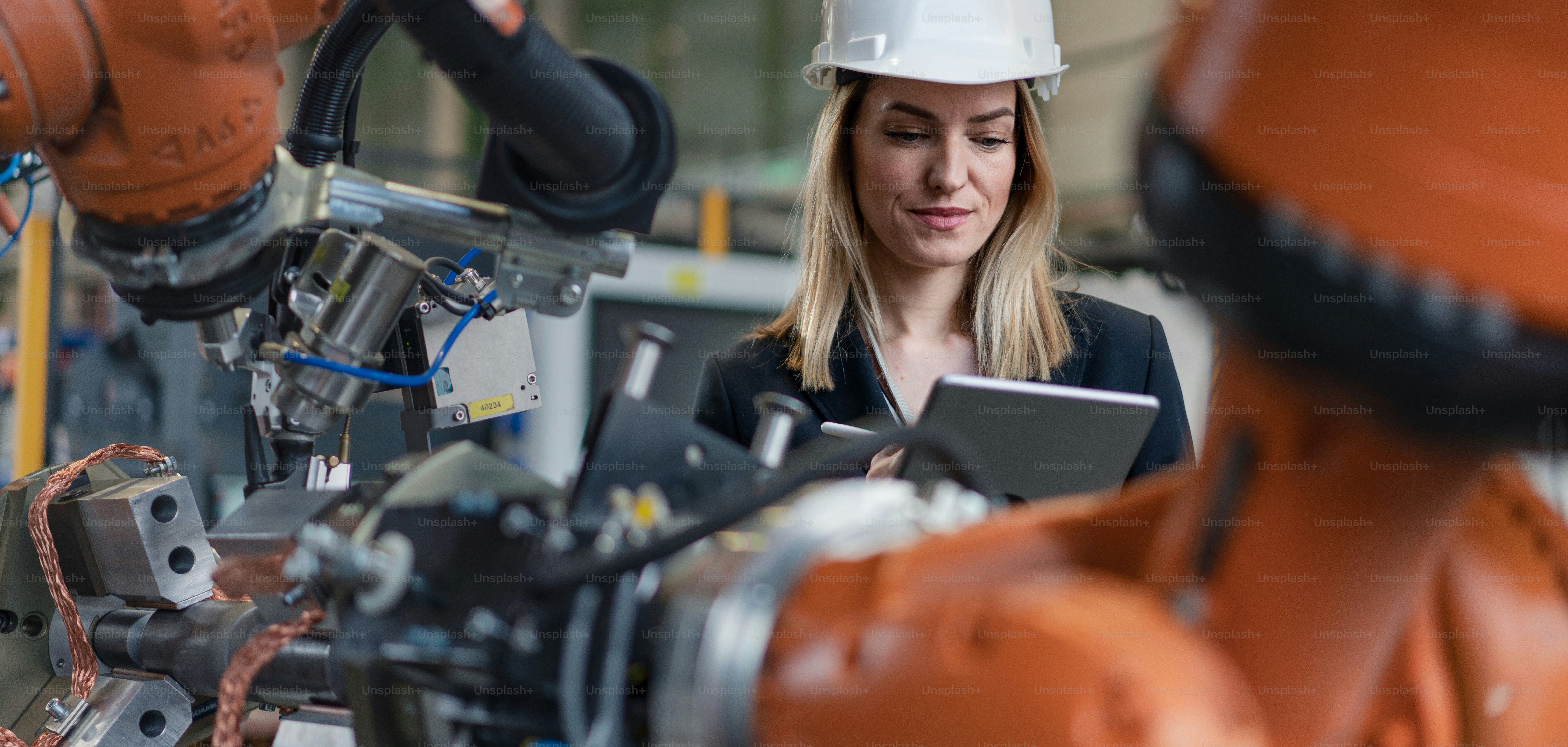 A robot arm industrial miniature figure in hand of robotics engineer ...