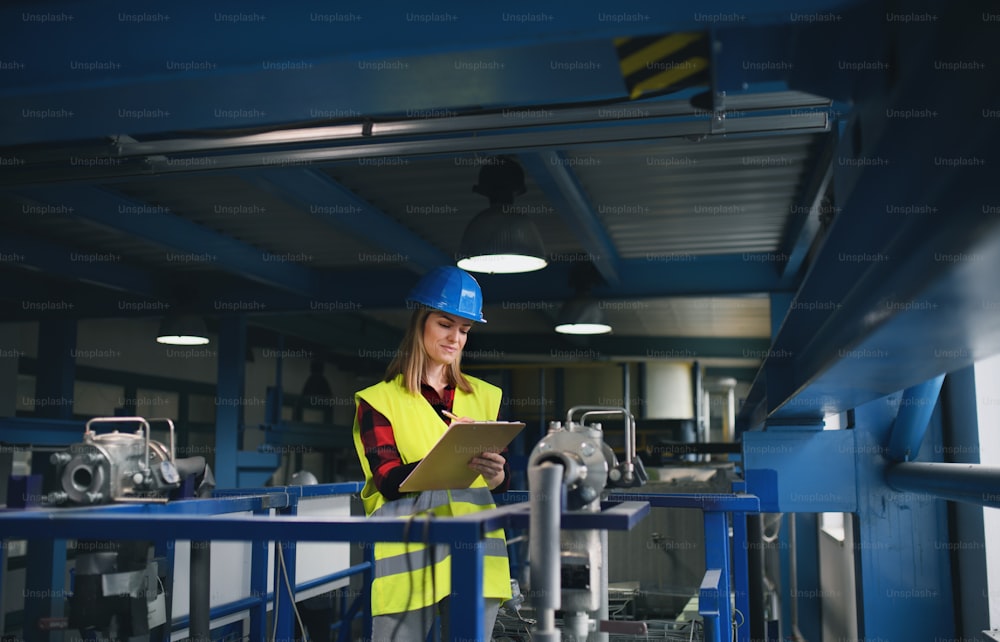 A portrait of female engineer working in industrial factory